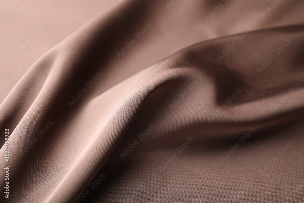 Fototapeta premium Crumpled light brown silk fabric as background, closeup