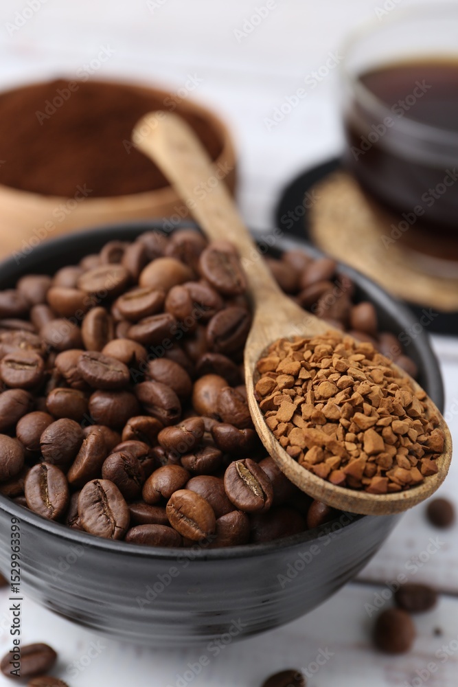 Fototapeta premium Roasted beans and granulated instant coffee on white wooden table, closeup