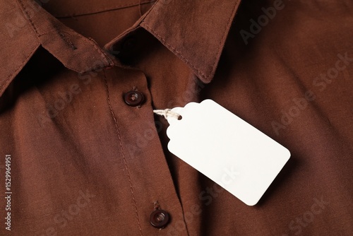Cardboard tag on brown shirt, above view