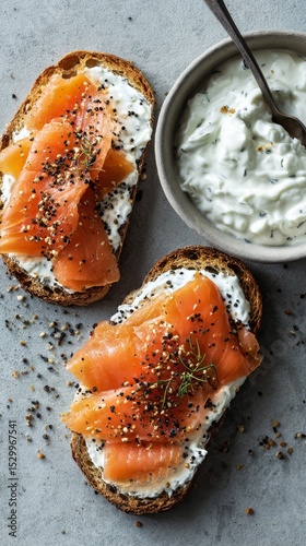 Delicious Smoked Salmon on Whole Grain Bread With Creamy Spread and Fresh Herbs.