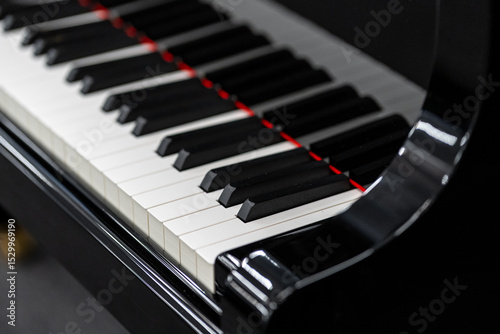 Close-up view of grand piano keyboard showing black and white keys