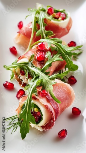 Gourmet Prosciutto Rolls With Arugula and Pomegranate on Elegant Plate