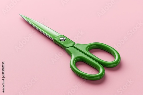 green scissors with stainless blades on pastel pink background