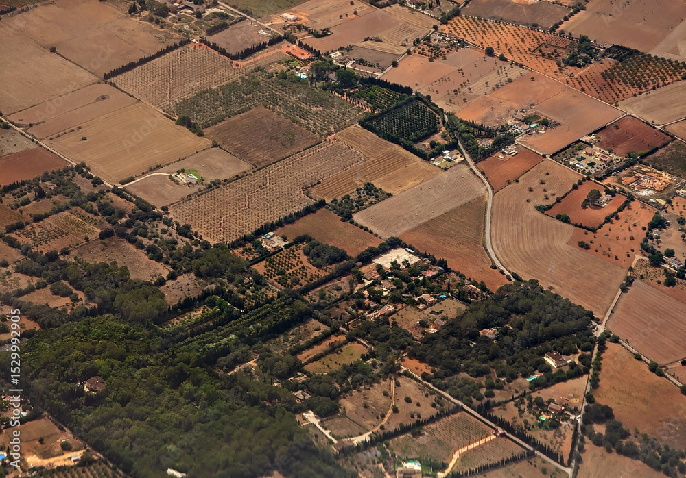 Fotografie Aerial view of Sencelles town municipality rustic country fincas and houses, rural plots, paths and roads, dryland farmland fields, brown ground lands and green nature, Mallorca, Balearic Islands