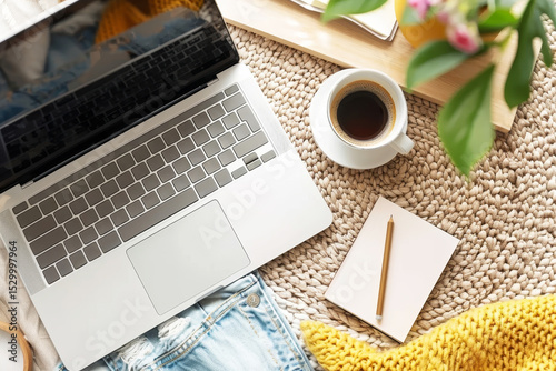 Flat lay mockup of blue denim and woven background with laptop, coffee cup, and notebooks