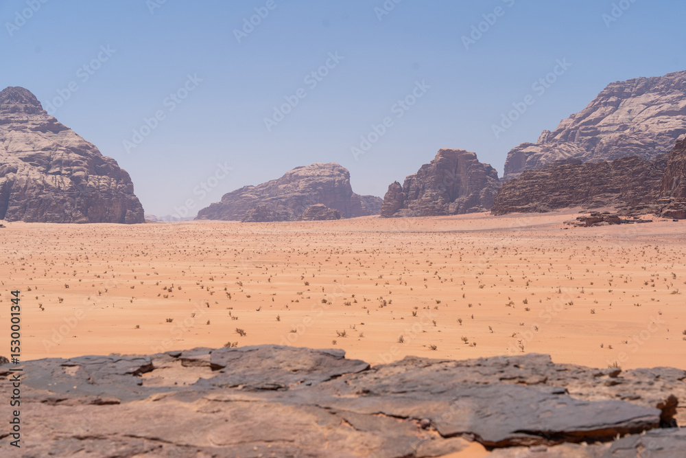 Fototapeta premium Majestic Desert Landscape: Witness the raw beauty of a vast desert landscape, with rugged rock formations and a boundless sky, evoking a sense of awe and timelessness.