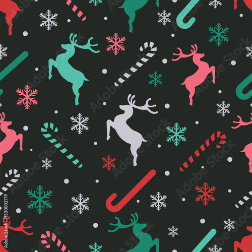 Vector decorative Christmas and new year Seamless Pattern. Holiday Ornamental silhouette deers, snowflakes and candy canes texture background in red, green and white. Greeting card backdrop template.