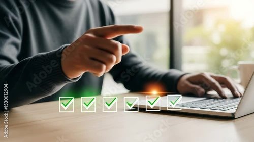 Man pointing at laptop with check marks overlayed on the screen in a bright office setting indoors