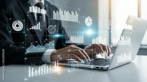 Person typing on laptop with data charts and graphs overlayed in a business setting office space