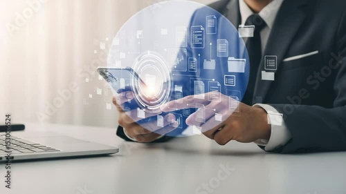 Businessman using smartphone with document icons and laptop on desk in bright office setting
