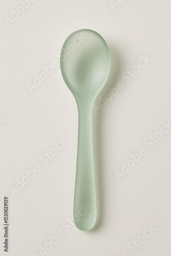 Frosted glass spoon on white background, minimalist elegant cutlery for modern table setting