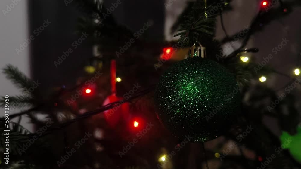 Twinkling Lights on the Christmas Tree. Christmas tree decoration in the form of a large green ball with flickering lights in the background