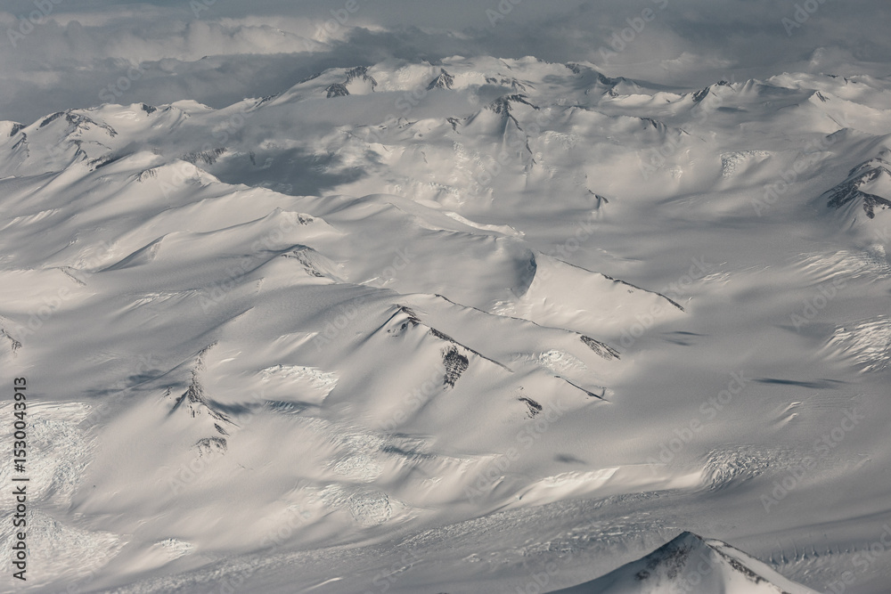 Fototapeta premium Aerial view of snowy mountains in Antarctica.