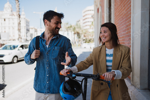 Man and woman in town with e scooter, exploring new town
