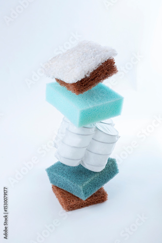 Wallpaper Mural Close-up of floating mattress layers, featuring memory foam, spring coils, and coconut coir. Suspended in mid-air against a white background, showcasing innovative mattress design and comfort. Torontodigital.ca