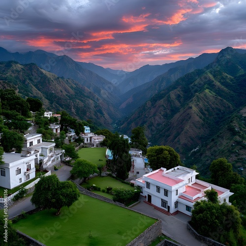 Scenic mountain valley at sunset, with white buildings nestled in the hills