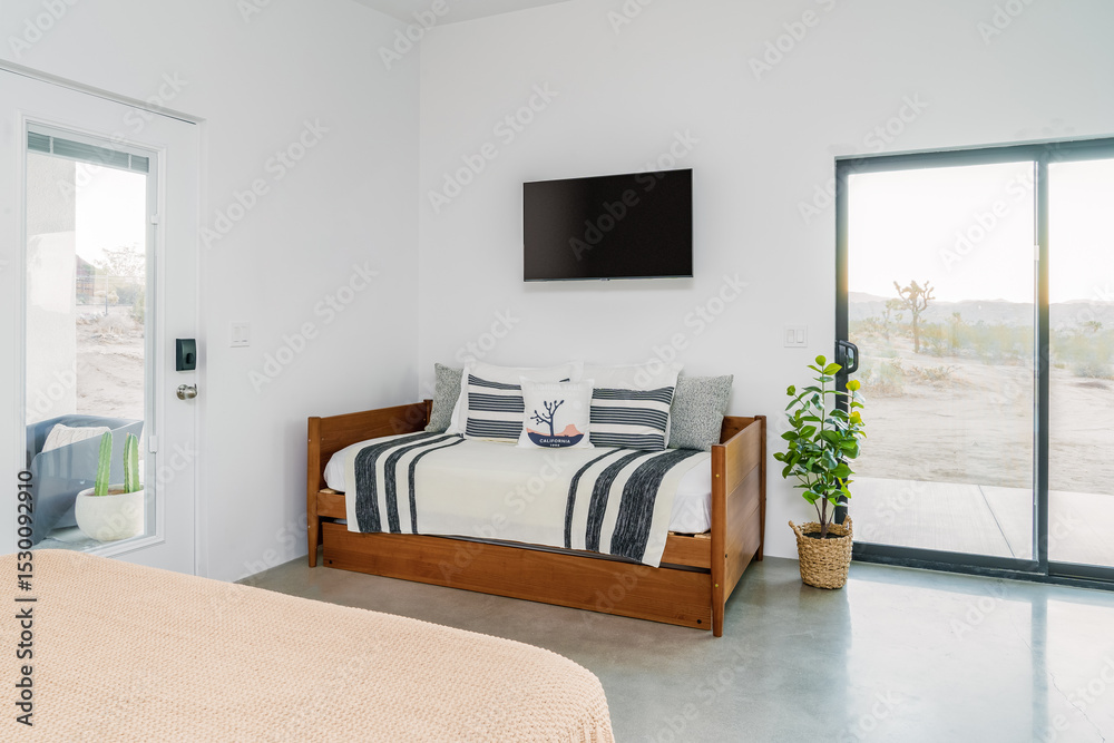 Fototapeta premium Modern desert interior with daybed, flat screen TV, concrete floors