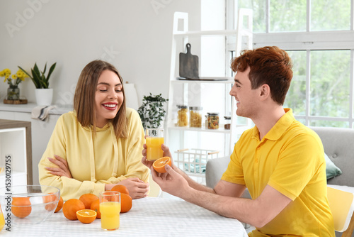 Young man giving glass of o...