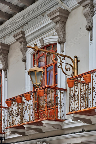 Fotografie Ornate balcony with decorative wrought iron railing and terracotta flower pots,