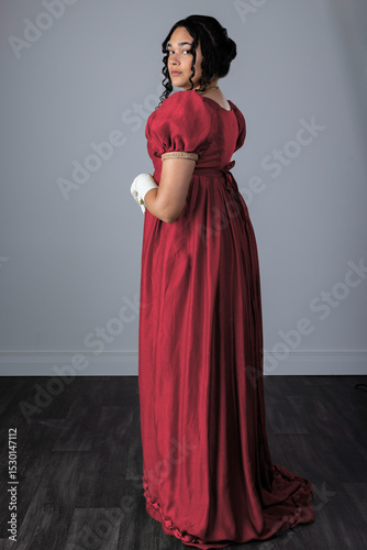 A Regency woman wearing an evening dress with gloves