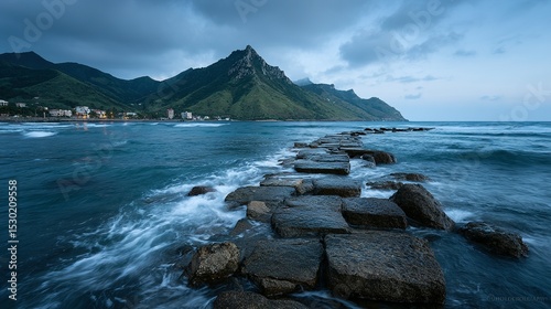 Cobblestone path leading into a body of water at twilight.