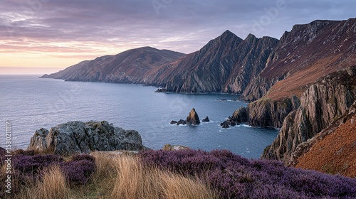 Dramatic coastal landscape with rugged cliffs and a tranquil sea.