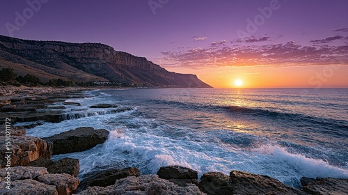 Dramatic sunrise over a rocky coastline.