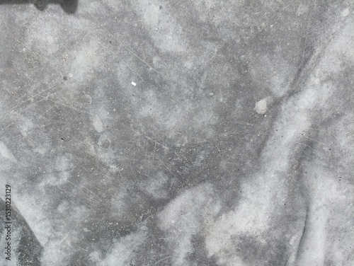 Distressed Grey Tarp Texture. A close-up of a well-worn and faded grey tarp, exhibiting abstract patterns and subtle creases