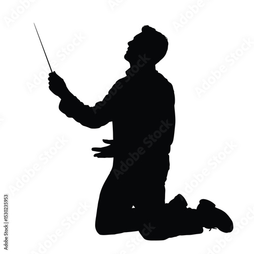 Silhouette of a conductor kneeling with baton raised upwards in passion