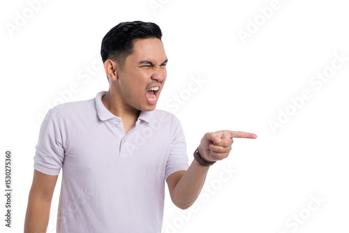 Angry young Asian man yelling and pointing finger aggressively to the side isolated on transparent background