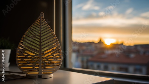 Leaf-shaped lamp near window, sunset view