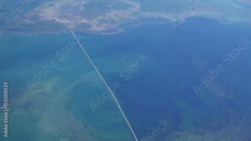 Aerial shot from a commercial airline over Cuba. Over the Bay of Dogs, Bahia de Perros, with the long causeway to Cayo Coco seen.