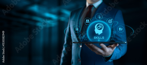 Businessman holding tablet with Skills icons on screen - Education and E-Learning Concept