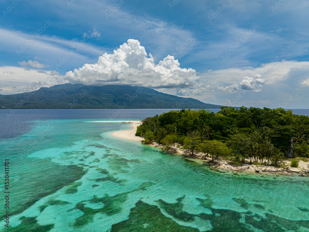 Fototapeta premium Natural beauty of Mantigue Island. Clear turquoise water and corals in atoll. Camiguin, Philippines.
