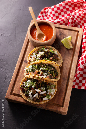 Mexican Street Tacos, Tacos de Suadero. Fried meat in a corn tortilla. Street food from CDMX, Mexico, traditionally accompanied with cilantro, onion and spicy red sauce