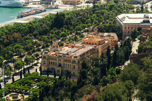 Lush cityscape with historic building and harbor view.