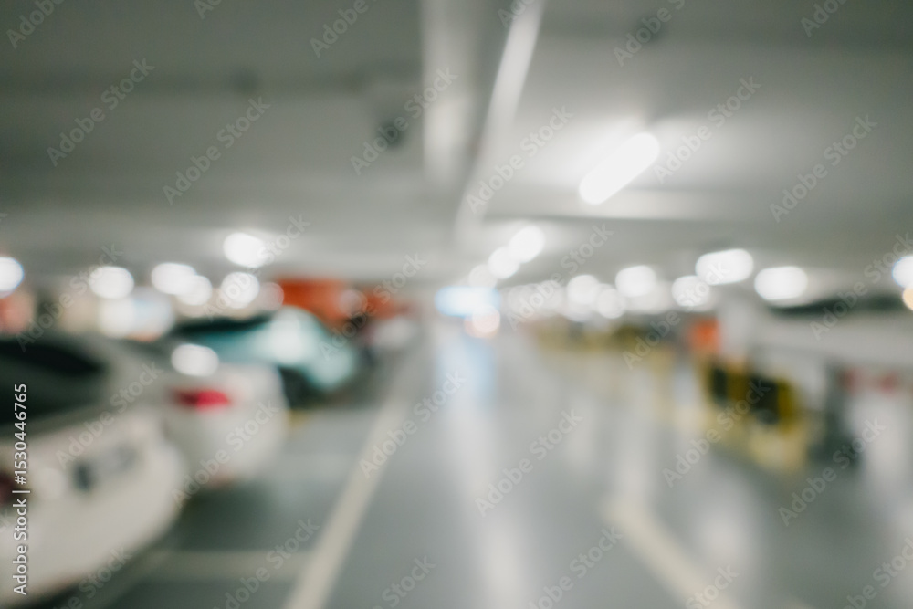 Bokeh for background. Blurred Interior of a Modern Parking Garage with Illuminated Spaces and Vehicles in Entangled Perspective Bokeh for background. Blurred Interior of a Modern Parking Garage with Illuminated Spaces and Vehicles in Entangled Perspective