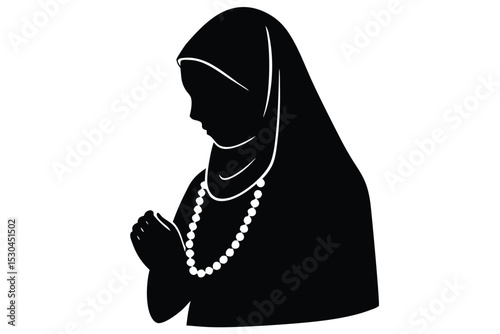 Young girl prayerfully holding islamic tasbih beads