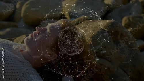 Woman lying supine on pebbles at sunset and emerging data sphere pulsing violet glow around head