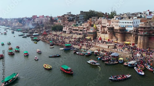 Varanasi, Uttar Pradesh, India-25th February 2025- 
Aerial view drone shot of Varanasi ghat area, showing Ganga River widely spread and huge number of row boats flowing through the river.