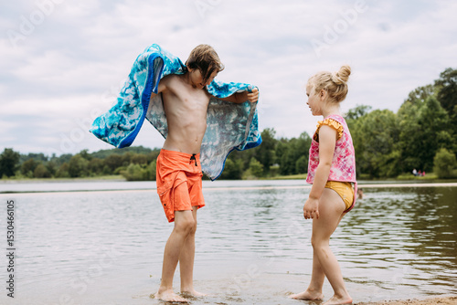 Kids playing lakeside on warm summer day