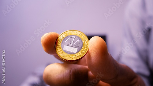 Black African person Hand holding shoing ointing single one 1 Ghanaian cedi coin in a room. close up of Hand holding coin