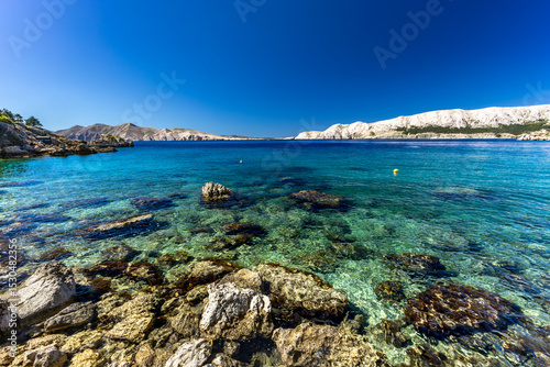 Fototapeta Naklejka Na Ścianę i Meble -  Jablanova Beach on the island of KRK in Croatia, blue trail leading to an empty pebble beach,