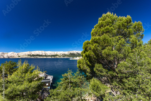Fototapeta Naklejka Na Ścianę i Meble -  Jablanova Beach on the island of KRK in Croatia, blue trail leading to an empty pebble beach,