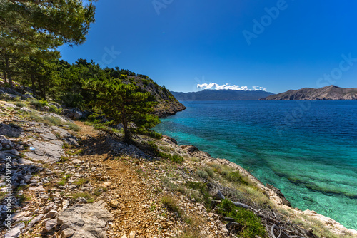 Fototapeta Naklejka Na Ścianę i Meble -  Jablanova Beach on the island of KRK in Croatia, blue trail leading to an empty pebble beach,