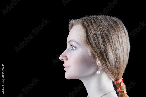 Headshot Portrait of Smiling Caucasian Blond Girl Profile Image With Calm Tranquil Positive Expression Over Black Background