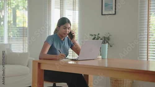 Young adult Gen Z people black asia woman busy phone call work at home using laptop AI search data hybrid workplace. Stock trade IT reskill upskill asian cyber typing coding. Online income tax apply
