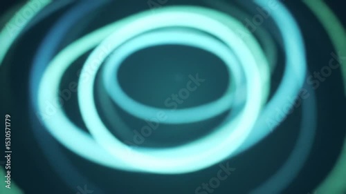 Abstract digital art of light blue and green circles swirls, and spirals in a wave pattern, creating a futuristic, energetic backdrop