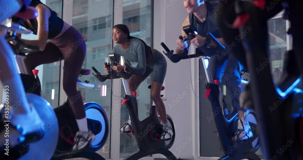Bike, fitness and group with people in spin class for cardio improvement or cycling at night. Exercise, training performance and stationary spinning with athletes in gym for late evening challenge
