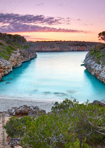 Serene Sunrise Over a Turquoise Bay Amid Cliffs on Mallorca